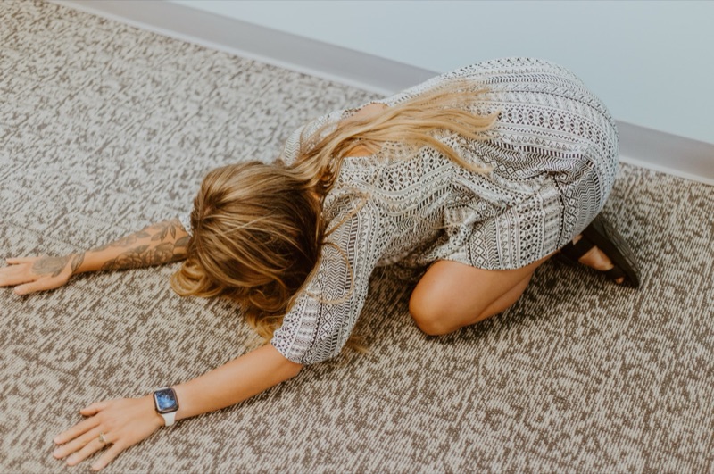 Child's pose with the hips settled back toward the heels and arms extended